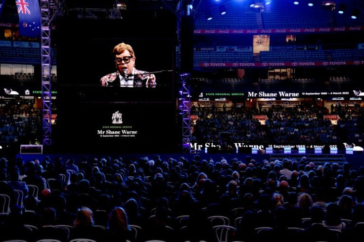 Elton John dedicates a song to Shane Warne on a big screen during the state memorial service for the former Australian cricketer