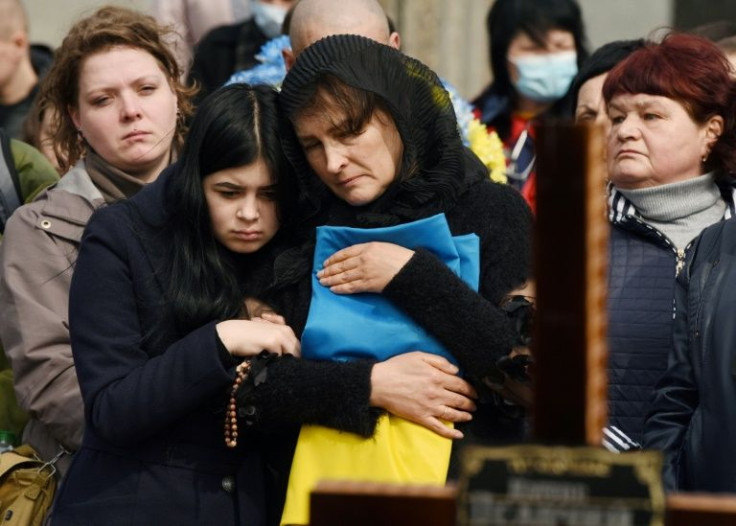 Relatives attend a ceremony at the funeral of the soldier Teodor Osadchyi, killed during the Russian invasion, at Lychakiv cemetery in Lviv, western Ukraine