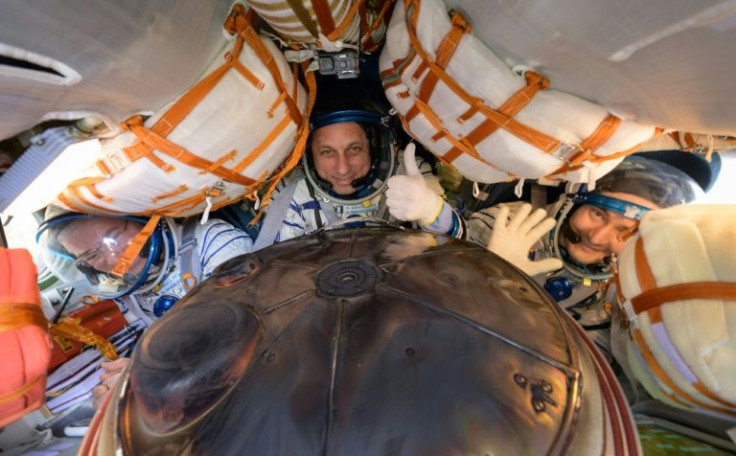 NASA astronaut Mark Vande Hei (l) with Russian cosmonauts Anton Shkaplerov (c) and Pyotr Dubrov inside the Soyuz MS-19 space capsule shortly after the landing on Wednesday