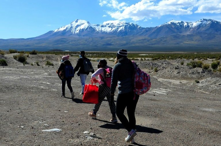 Venezuelan migrants brave the many dangers and discomforts such as the cold and altitude to cross from Bolivia into Chile near the village of Pisiga