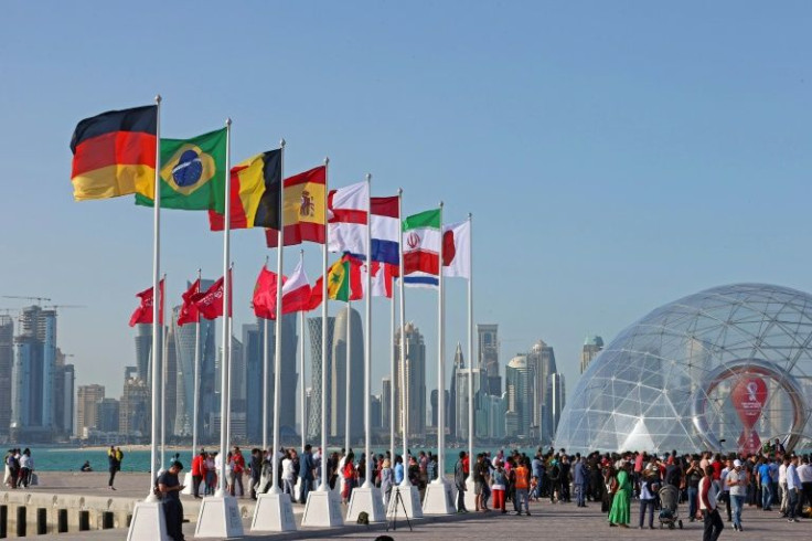 Flags of the countries qualified for this year's World Cup flutter on the seafront in Doha