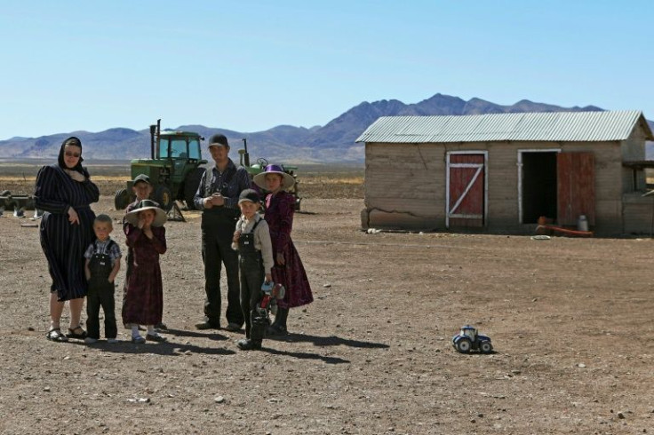 A Mennonite family poses for a picture in the village of Sabinal, where traditions meet modernity following the arrival of electricity and the internet