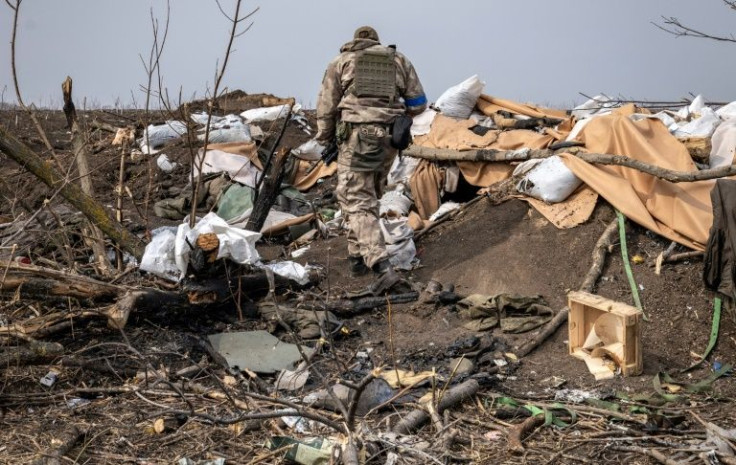 A Ukrainian soldier patrols near the village of Mala Rogan, east of Kharkiv, on March 30, 2022