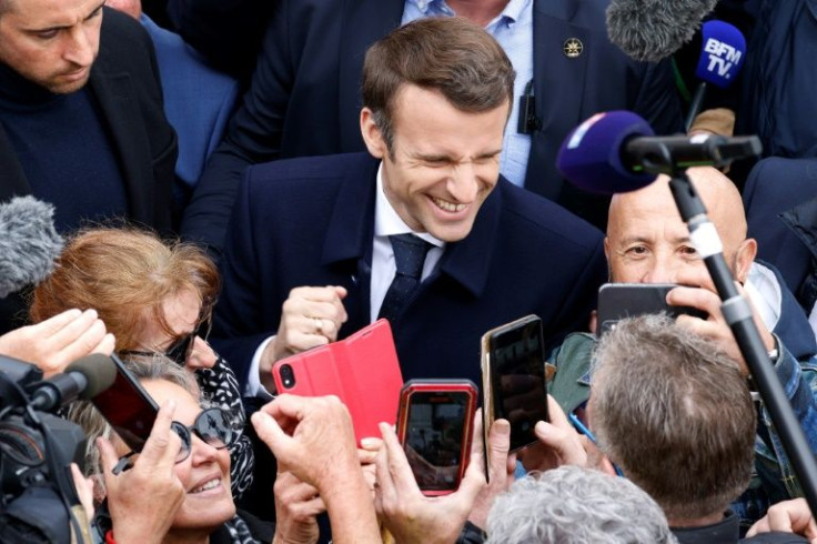 President Emmanuel Macron (C) has stepped up campaigning after weeks tied up with the Ukraine crisis