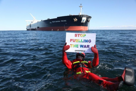 Greenpeace activists blocked two Russian tankers from transferring 100,000 tonnes of crude oil off the Danish coast