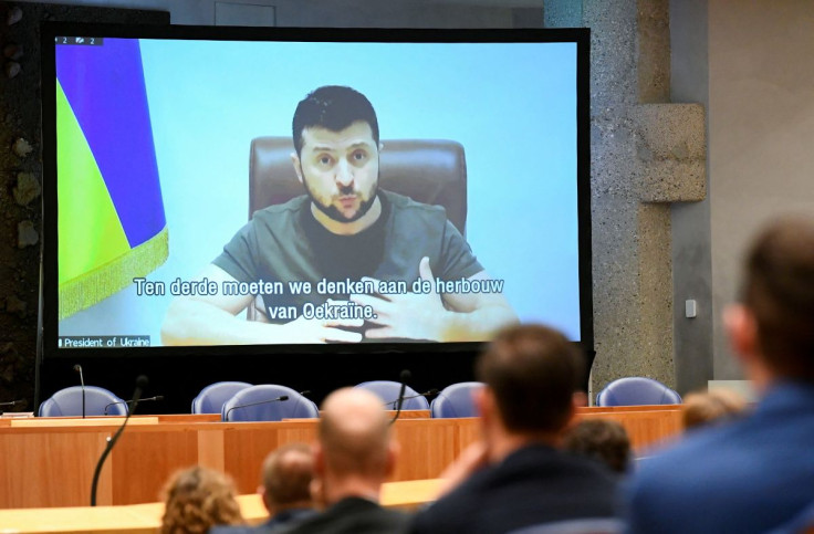 Ukrainian President Volodymyr Zelenskiy appears on screen as he addresses the members of Dutch parliament via video link, amid Russia's invasion of Ukraine, in The Hague, Netherlands, March 31, 2022.