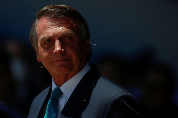 Brazil's President Jair Bolsonaro looks on during a welcoming ceremony to receive Brazilians and foreigners evacuated from Ukraine during a repatriation mission, at Brasilia Air Base, in Brasilia, Brazil March 10, 2022. 