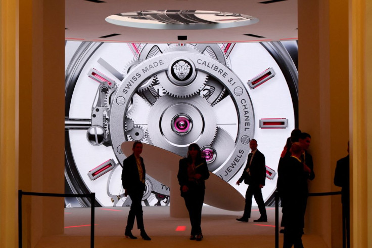 People attend the Watches and Wonders exhibition near the Chanel booth in Geneva, Switzerland, March 30, 2022.