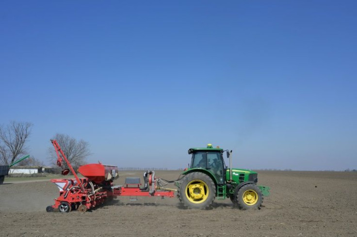 A farmer drives a tractor as he works in the field at Bogatoye village in Ukraine on March 24, 2022