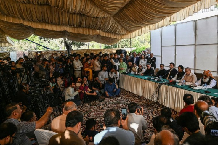 Pakistan opposition leaders address the press after the defection of a government coalition member to their ranks