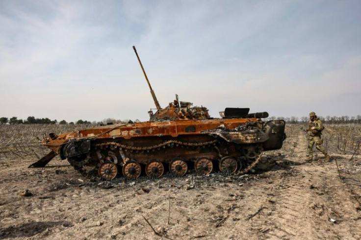 An Russian armoured personnel carrier sits in a barren wasteland of sunflower stalks