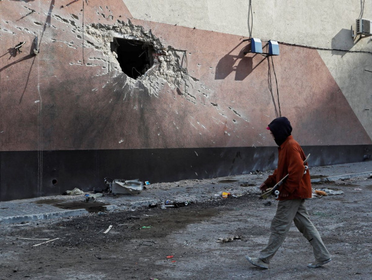 A local resident walks past a building damaged during Ukraine-Russia conflict in the besieged southern port city of Mariupol, Ukraine March 31, 2022.