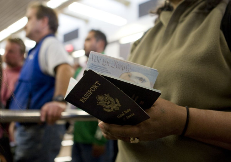 A woman holds passports while waiting to cross at the San Ysidro border crossing in San Ysidro, California January 31, 2008.  