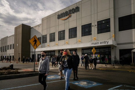 Workers walk to cast their votes over whether or not to unionize, outside an Amazon warehouse in Staten Island on March 25, 2022