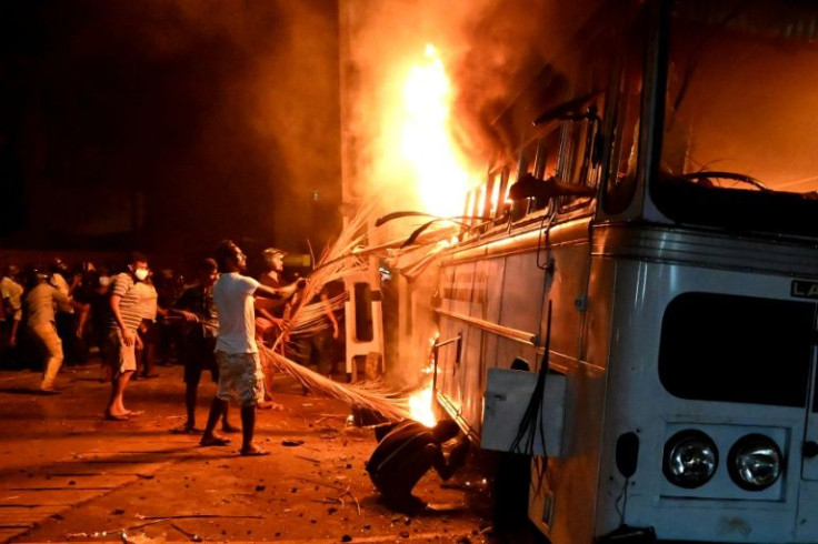 Hundreds of people marched on the president's home demanding his resignation, setting two vehicles ablaze