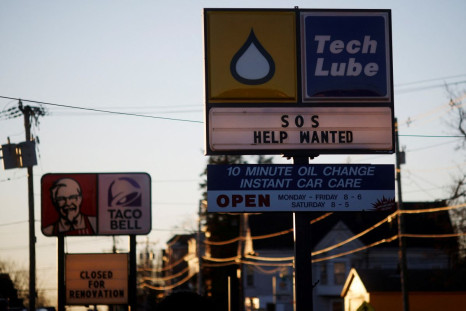 The sign at an automobile oil-change shop reads "Sos Help Wanted" in Brockton, Massachusetts, U.S., January 4, 2022.   