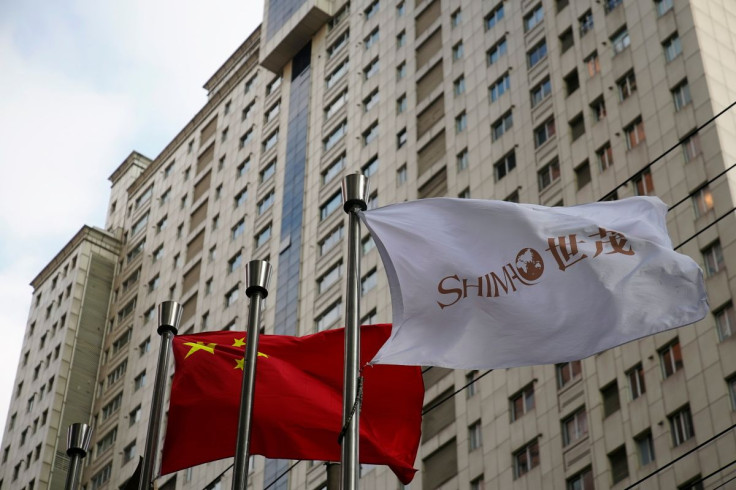 The flag of property developer Shimao Group flutters next to a Chinese flag in Shanghai, China January 13, 2022.