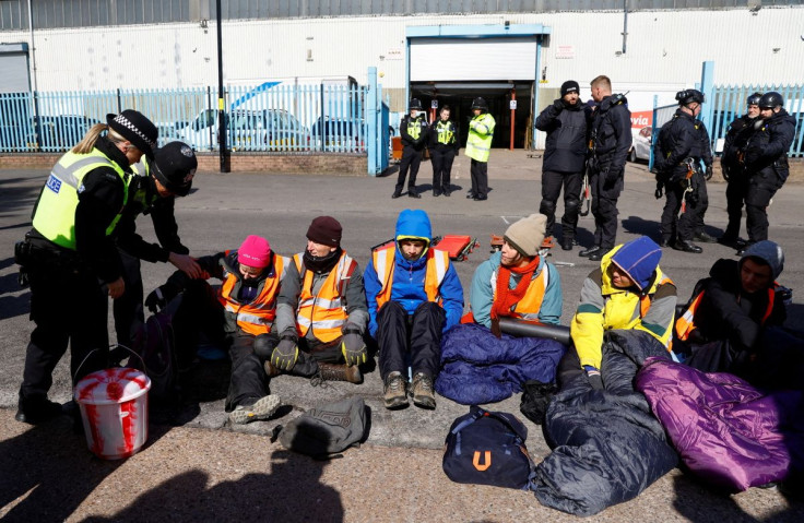 Police officers detain Just Stop Oil activists for obstruction of the highway during a protest outside the Esso Birmingham fuel terminal, in Birmingham, Britain April 1, 2022.