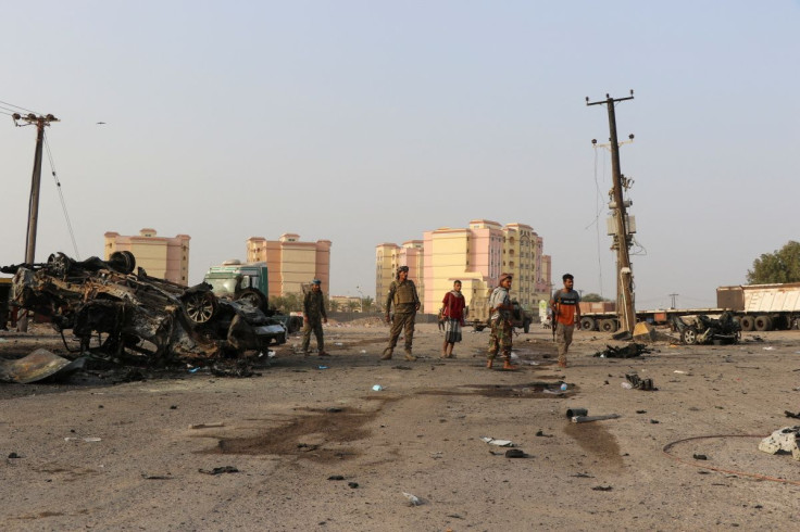 Soldiers stand by the wreckage of a vehicle at the scene of a car bomb attack in the southern port city of Aden, Yemen March 24, 2022.