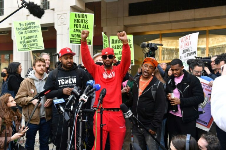 Union organizer Christian Smalls (C) celebrates as he speaks following the April 1, 2022, vote for the unionization of the Amazon Staten Island warehouse in New York