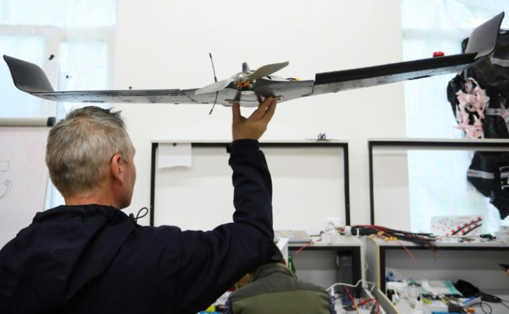 A Ukrainian activist examines one of the drones constructed at a secret location in Lviv