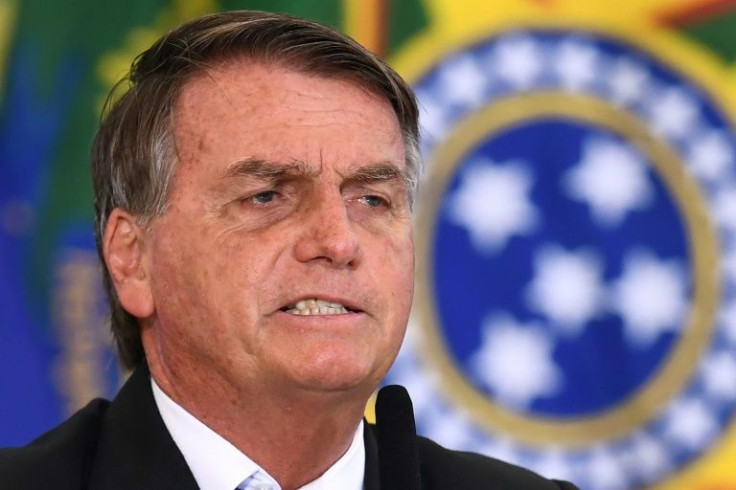 Brazilian President Jair Bolsonaro speaks during the inauguration ceremony of new ministers at the Planalto Palace in Brasilia, on March 31, 2022. Bolsonaro on Thursday fired key ministers who will contest the October elections, including his possible run