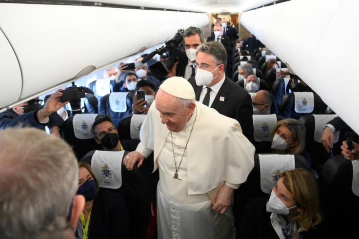 Pope Francis greets journalists aboard a plane on his way to Malta April 2, 2022. Vatican Media/ÂHandout via REUTERS