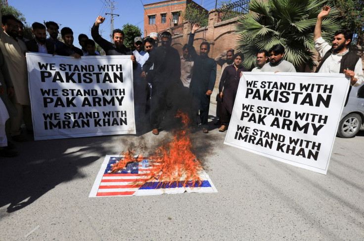 Supporters of the Pakistan Tehreek-e-Insaf (PTI) political party, burn the U.S. flag, accusing the U.S. of plotting to overthrow Pakistani Prime Minister Imran Khan, during a protest in Peshawar, Pakistan, April 1, 2022.