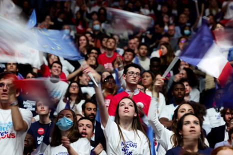 People attend a political campaign rally for French President Emmanuel Macron, candidate for his re-election in the 2022 French presidential election, at Paris La Defense Arena in Nanterre, France, April 2, 2022. Picture taken with slow shutter speed. 