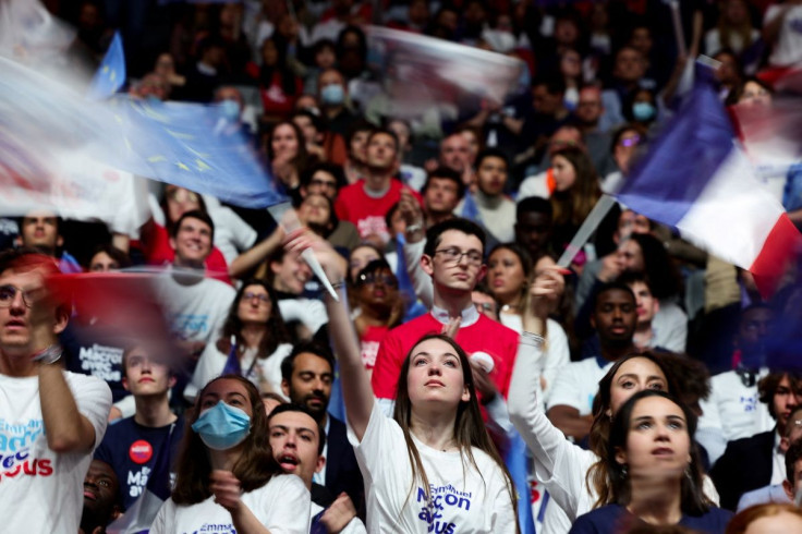 People attend a political campaign rally for French President Emmanuel Macron, candidate for his re-election in the 2022 French presidential election, at Paris La Defense Arena in Nanterre, France, April 2, 2022. Picture taken with slow shutter speed.