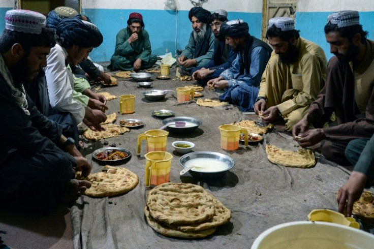 Members of the Taliban break their iftar fast on the first day of Ramadan, in the southern Afghan city of Kandahar