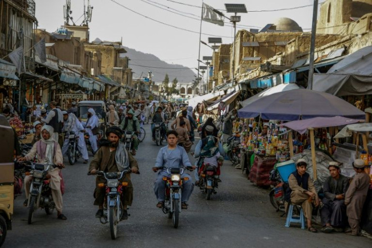 People crowd a market area on the first day of Ramadan in Kandahar, as Afghanistan marks the first holy fasting month since the Taliban seized power last August