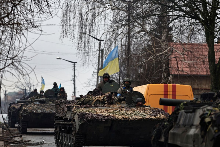 Ukrainian soldiers are pictured on their tanks as they drive along the street, amid Russia's invasion on Ukraine, in Bucha, in Kyiv region, Ukraine April 2, 2022. 