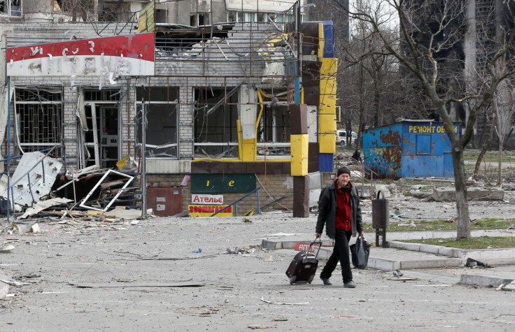 A man walks near a building damaged in the course of Ukraine-Russia conflict in the southern port city of Mariupol, Ukraine April 1, 2022.