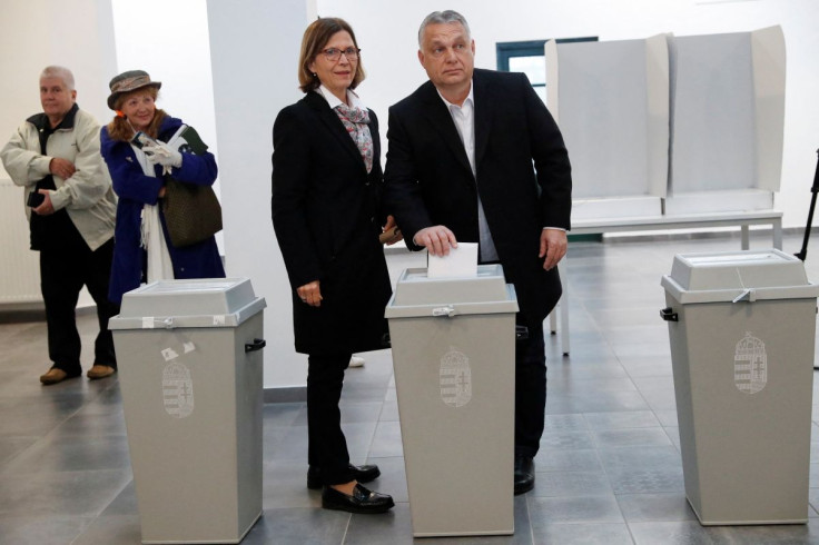 Hungarian Prime Minister Viktor Orban casts his vote while stood next to his wife Aniko Levai, at a polling station during the Hungarian parliamentary election, in Budapest, Hungary, April 3, 2022.