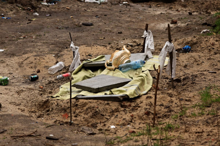 A grave where two men have been buried, who according to residents were shot dead in the eye by Russian soldiers, is seen at the garden of a building, amid Russia's invasion on Ukraine, in Bucha, Ukraine April 3, 2022. 