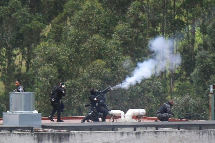 Riot police shoot tear gas to try to quash a riot at the El Turi prison in Cuenca, Ecuador, on April 3, 2022