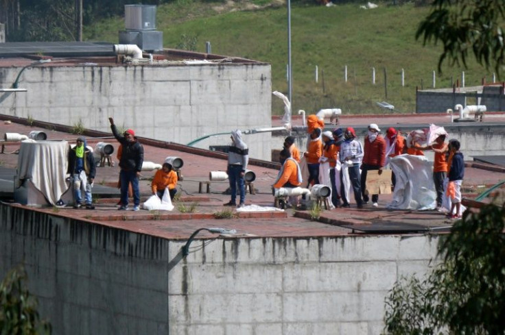 Inmates are seen on the roof of the CRS Turi prison after a riot in Cuenca, Ecuador, on April 3, 2022.At least 12 people died in a prison riot early Sunday in southern Ecuador, the president's office said, the latest outburst of deadly violence in the Sou