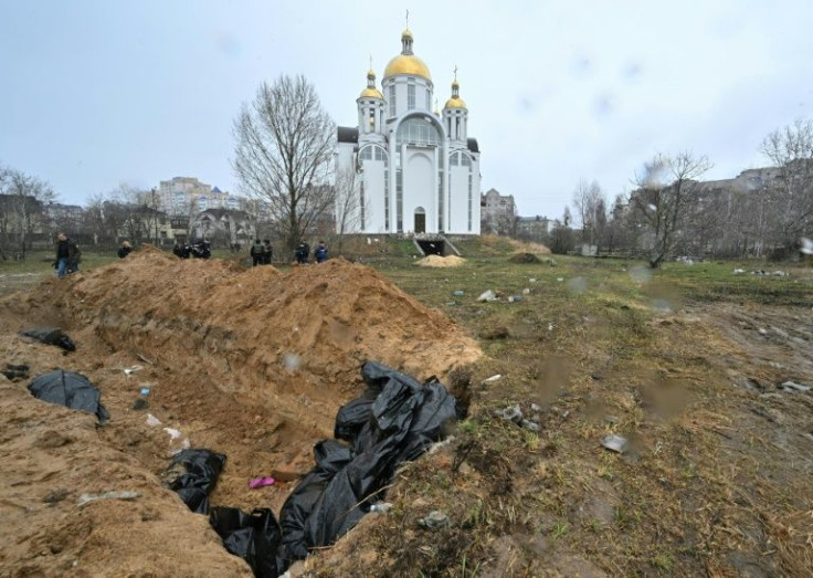 A mass grave is seen behind a church in the town of Bucha, northwest of the Ukrainian capital Kyiv on April 3