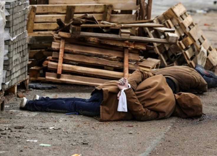 The body of a man, with his wrists tied behind his back, lies on a street in Bucha, just northwest of the capital Kyiv