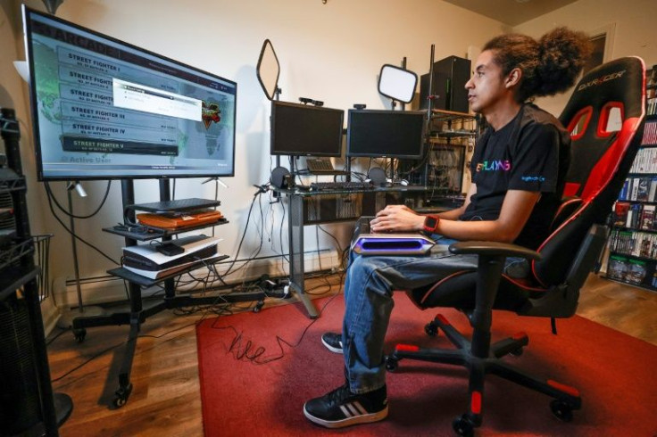 Chris Robinson plays a video game in his apartment on March 26, 2022, in Justice, Illinois. Robinson, who was born deaf, hosts DeafGamersTV channel on video game streaming site Twitch
