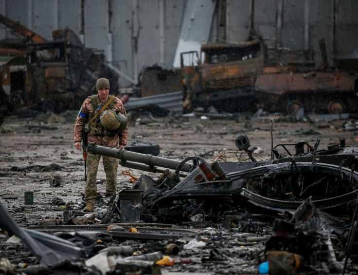 A Ukrainian service member inspects a compound of the Antonov airfield, as Russia's attack on Ukraine continues, in the settlement of Hostomel, in Kyiv region, Ukraine April 3, 2022. 