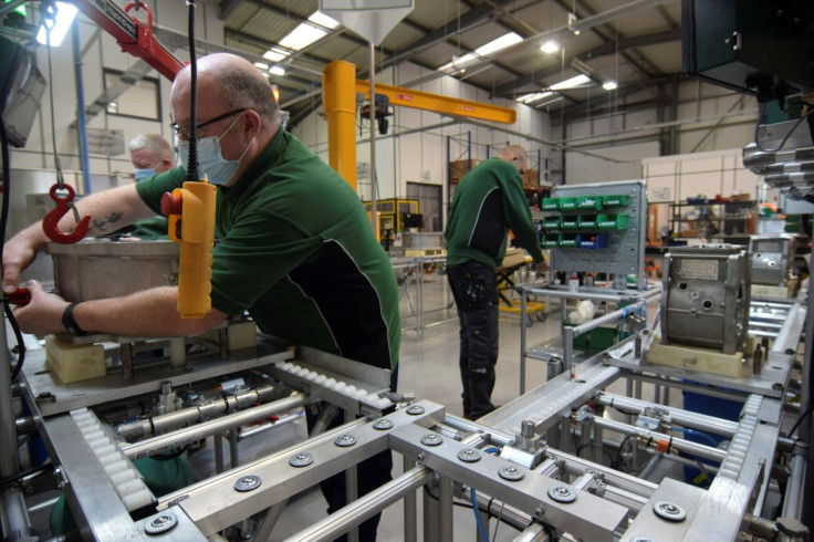 Employees at Advanced Electric Machines work on test models of a motor for an electric vehicle that does not include either rare earth magnets or copper and uses electrical steel and aluminium instead, in Washington, Britain, November 26, 2021. Picture ta