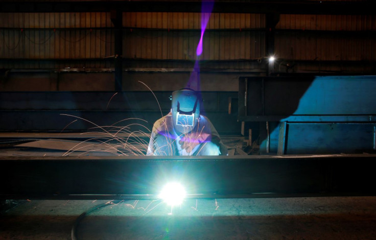 A labourer welds an iron pillar at a building material factory in an industrial area in Dasna, in the central Indian state of Uttar Pradesh, India, January 9, 2019. 