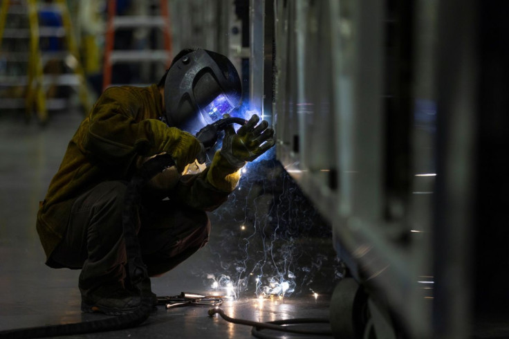 A welder works while building a bus frame at the BYD electric bus factory in Lancaster, California, U.S., July 1, 2021. Picture taken July 1, 2021.   