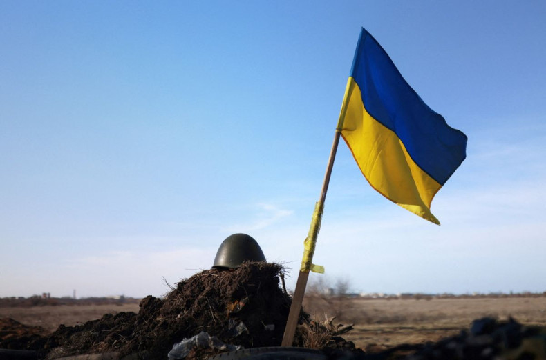 A Ukrainian flag and a helmet of a soldier are pictured at checkpoint, as Russia's invasion of Ukraine continues, in Mykolaiv, Ukraine, March 28, 2022. 