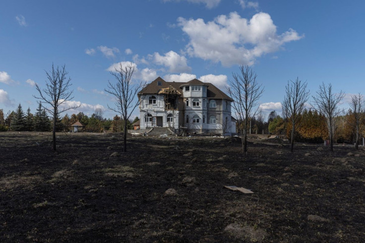 A destroyed house is pictured near where the head of the village, her husband and son were shot and buried in a shallow grave, as Russia's invasion of Ukraine continues, in the village of Motyzhyn, outside Kyiv, Ukraine, April 4, 2022.