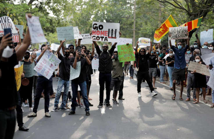 People carrying signs shout slogans against Sri Lanka's President Gotabaya Rajapaksa and demand that Rajapaksa family politicians step down, during a protest amid the country's economic crisis, on a main road in Colombo, Sri Lanka, April 4, 2022.