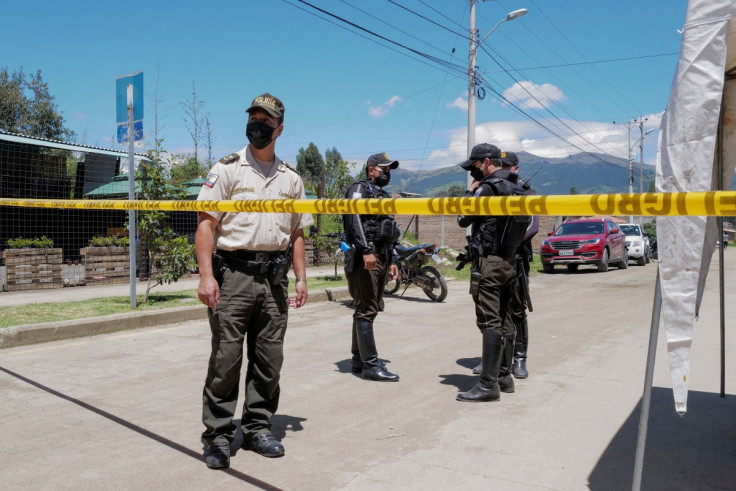 Officials guard the entrance to a morgue after a deadly riot broke out at the El Turi prison, in Cuenca, Ecuador April 4, 2022.