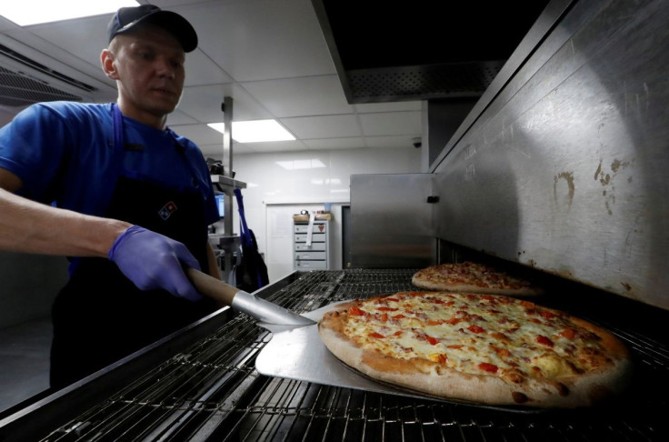A staff member prepares pizzas at a Domino's Pizza restaurant in Moscow, Russia, July 14, 2017.